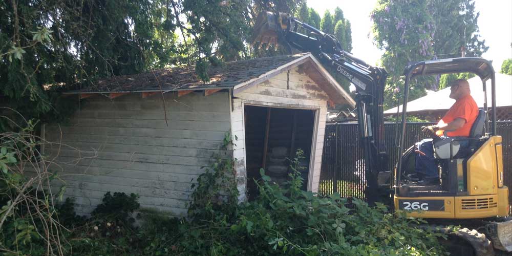 Shed Removal & Outbuilding Disposal Service - Image shows the excavation of a garage.